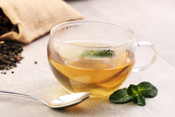 Tea. Herbal tea. Mint leaf. Tea in a glass cup, mint leaves, dried tea, sliced lime. herbs on a slate plate in a restaurant or teahouse