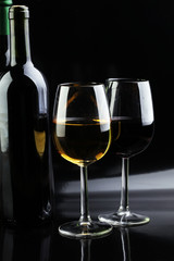 Wine glass and Bottle on black background. Red and white wine