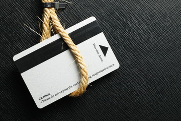 Old fashion type of credit card in the rope loop represent the card and technology concept related idea.