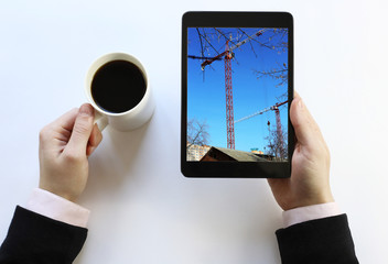 tablet in his hands. The construction manager. 