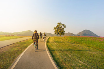 Female Friends cycling on hill in summer
