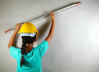 The girl in action of doing plaster work represent the people and construction concept related background.