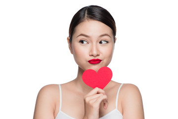 Attractive young woman with red heart. Valentine's day art portrait. Perfect make up