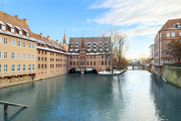 Fototapeta na wymiar Winter landscape of The Hospital of the Holy Spirit on Pegnitz river in Nuremberg, Bavaria, Germany