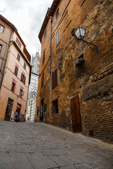 Medieval narrow street in Siena. Tuscany, Italy. 