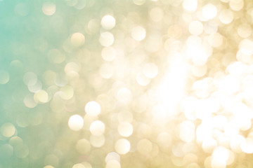 Festive abstract background with bokeh lights. Gold and green boke texture of Christmas Light.