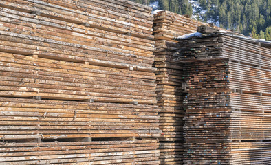 Drying timber boards at the sawmill in winter Alp Mountains