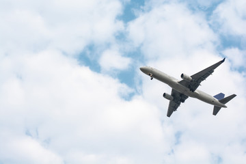 Fototapeta na wymiar Airplane take-off from runways at cloudy sky.