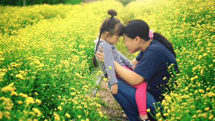 Mother and daughter in flower field