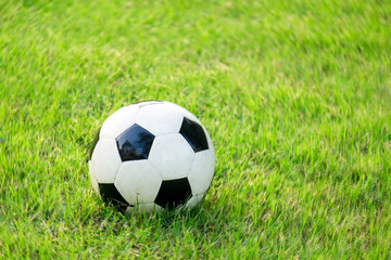 Fototapeta na wymiar Soccer ball on a soccer field in the morning light.