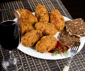 Homemade meat cutlets with parsley, ketchup and bread on white plate