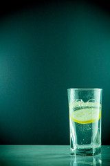 slice of lemon drops in a glass of water