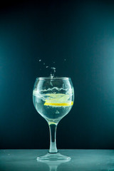 slice of lemon drops in a glass of water