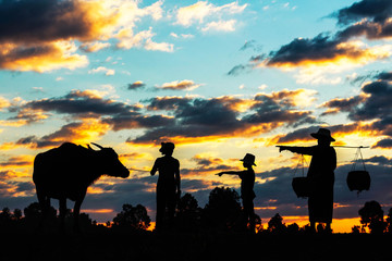 Family farmers at sunset.