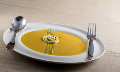cream of pumpkin soup with boiled egg and chives pepper