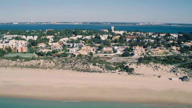 Flying Above Holiday Village on Shore Ocean