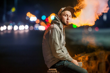 handsome young man smoking electronic cigarette