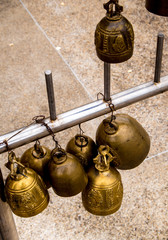 Fototapeta na wymiar Bunch of small brass bell in the temple