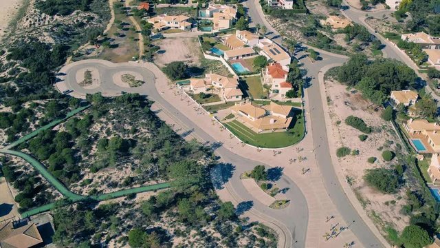 Flying Above Holiday Village on Shore Ocean