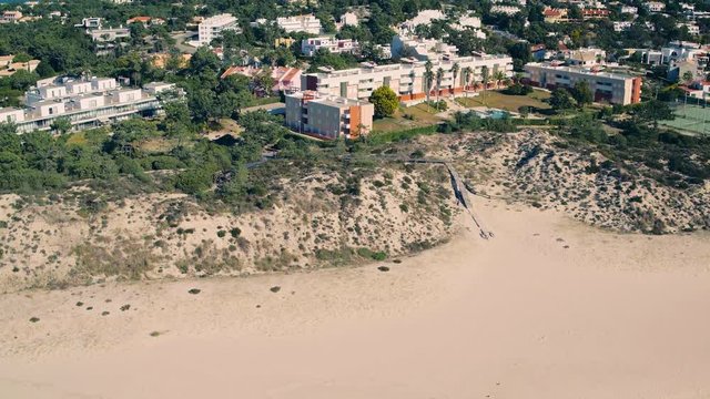 Flying Above Holiday Village on Shore Ocean