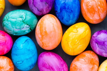 Easter eggs painted in colors on a pattern background.