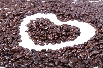 Coffee beans in shape of heart on white background