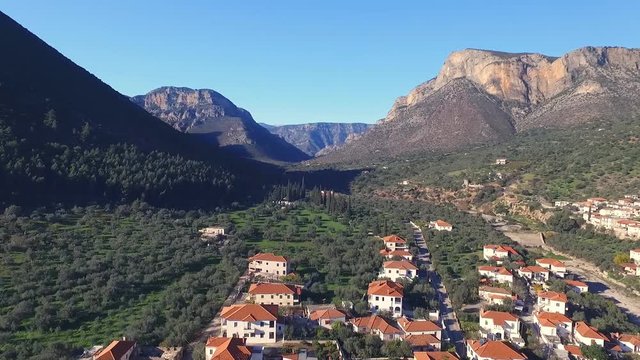 Drone flies over the gorge in the valley which is the Greek city of Leonidio.