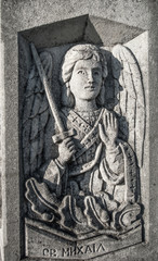 Fototapeta na wymiar Relief of angel on the grave