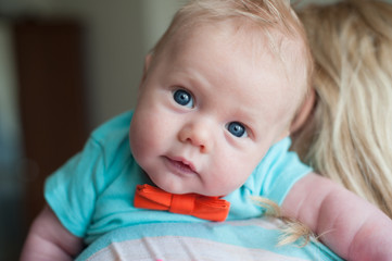 beautiful little kid looking over mother shoulder