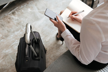 Cropped picture of young business woman sitting in office