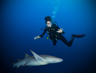 Underwater photo of woman diver with shark