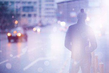 man winter in the city view from the back road cars