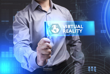 Business, Technology, Internet and network concept. Young businessman showing a word in a virtual tablet of the future: Virtual reality