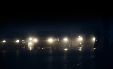 Headlights of cars driving in fog at night