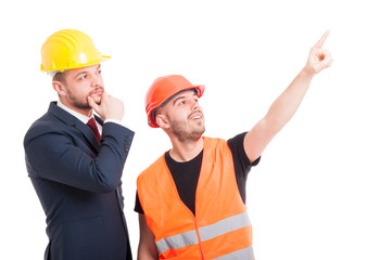 Handsome constructor pointing finger up