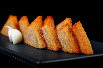 garlic bread isolated on black