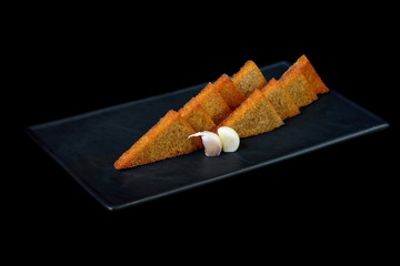 garlic bread isolated on black