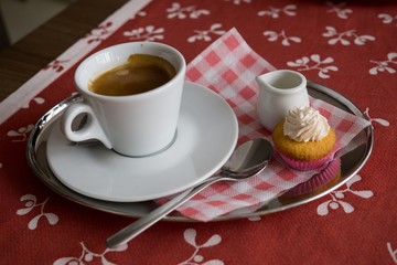 Cup of espresso coffee with milk and cake