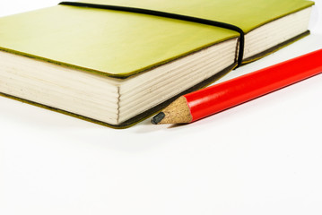 Green notebook with bookmark and pencil