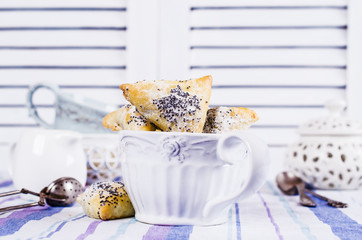 Triangular cookies with poppy seeds