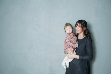 Mother with cute daughter portrait keep baby on hands