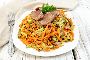 Salad of tongue and carrots on board