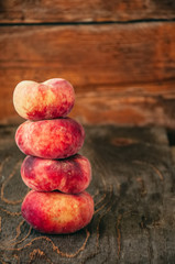 Group of fresh raw peaches on a wooden board. Toned.