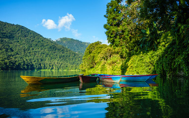 Colorful small boats on Phewa Lake in Pokhara, Nepal