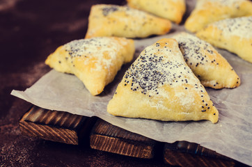 Triangular cookies with poppy seeds