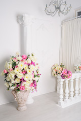 beautiful decoration of flowers in vases in white studio