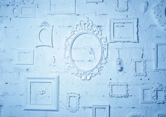 on the wall a lot of vintage frames in blue tones