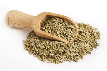 Pile of dried rosemary leaves with wooden scoop isolated on white background