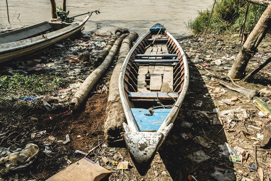 A Fisherman's Boat Left By Tide On Riverbank, Irrawaddy Delta, Myanmar