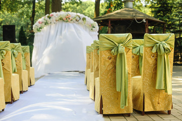 Wedding arch in the yellow and green colors in a sunny day wedding